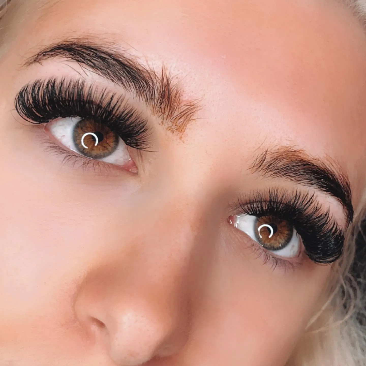 Dense volume lash extensions on brown eyes