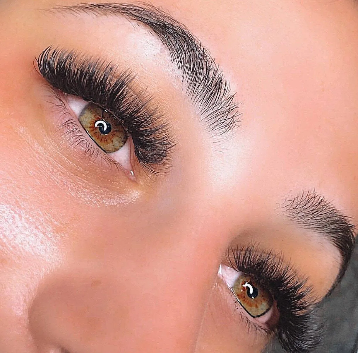 Completed mega-volume lash set with sculpted brows — wide-awake result