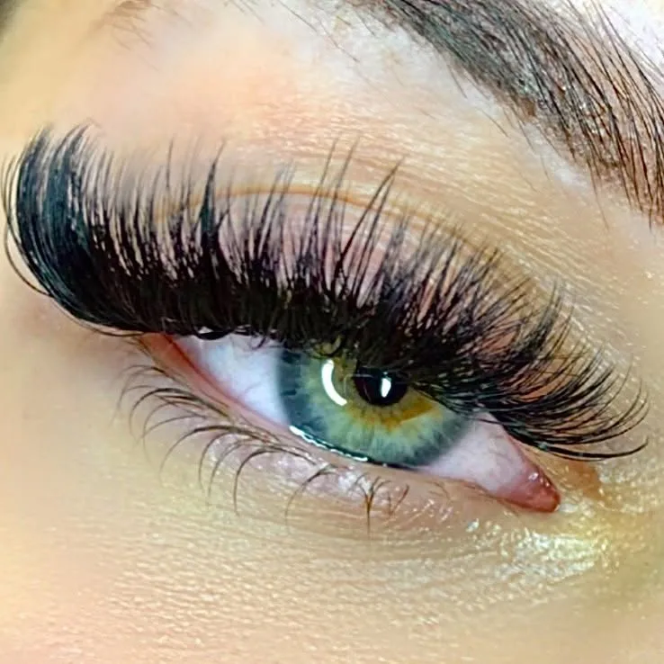 Dense volume extensions on green eyes with soft pink surround